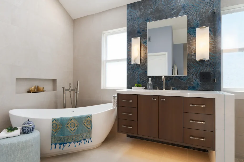 Contemporary bathroom with Crystal Cabinet Works vanity, featuring a freestanding bathtub, sleek wood cabinetry, and a bold accent tile wall