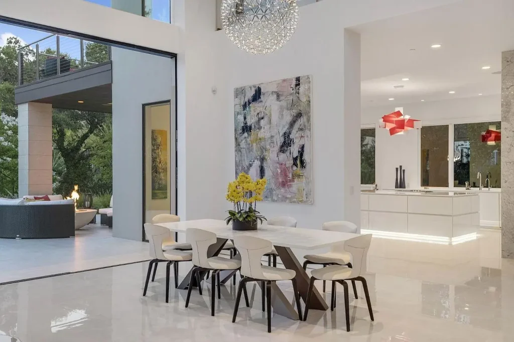 Mid-century modern kitchen featuring retro-inspired pendant lights and chairs, natural wood tones, and clean lines