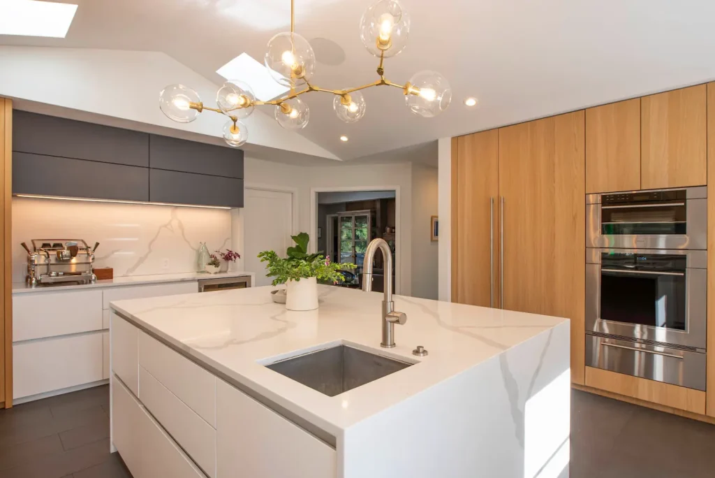 tylish modern kitchen with high-end finishes, a large central island, and a striking backsplash